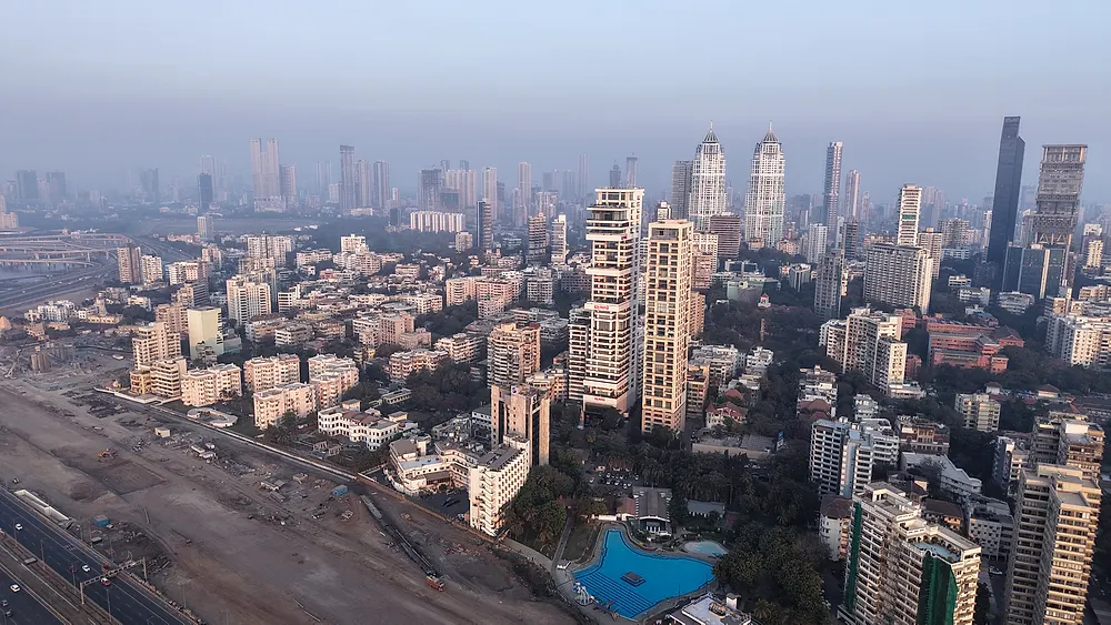 Wide aerial view over Mumbai with sea and skyline