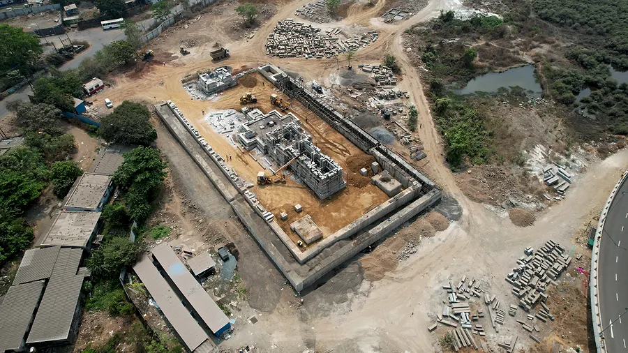 Aerial view, Apr 2025. Plinth complete. Columns rising.